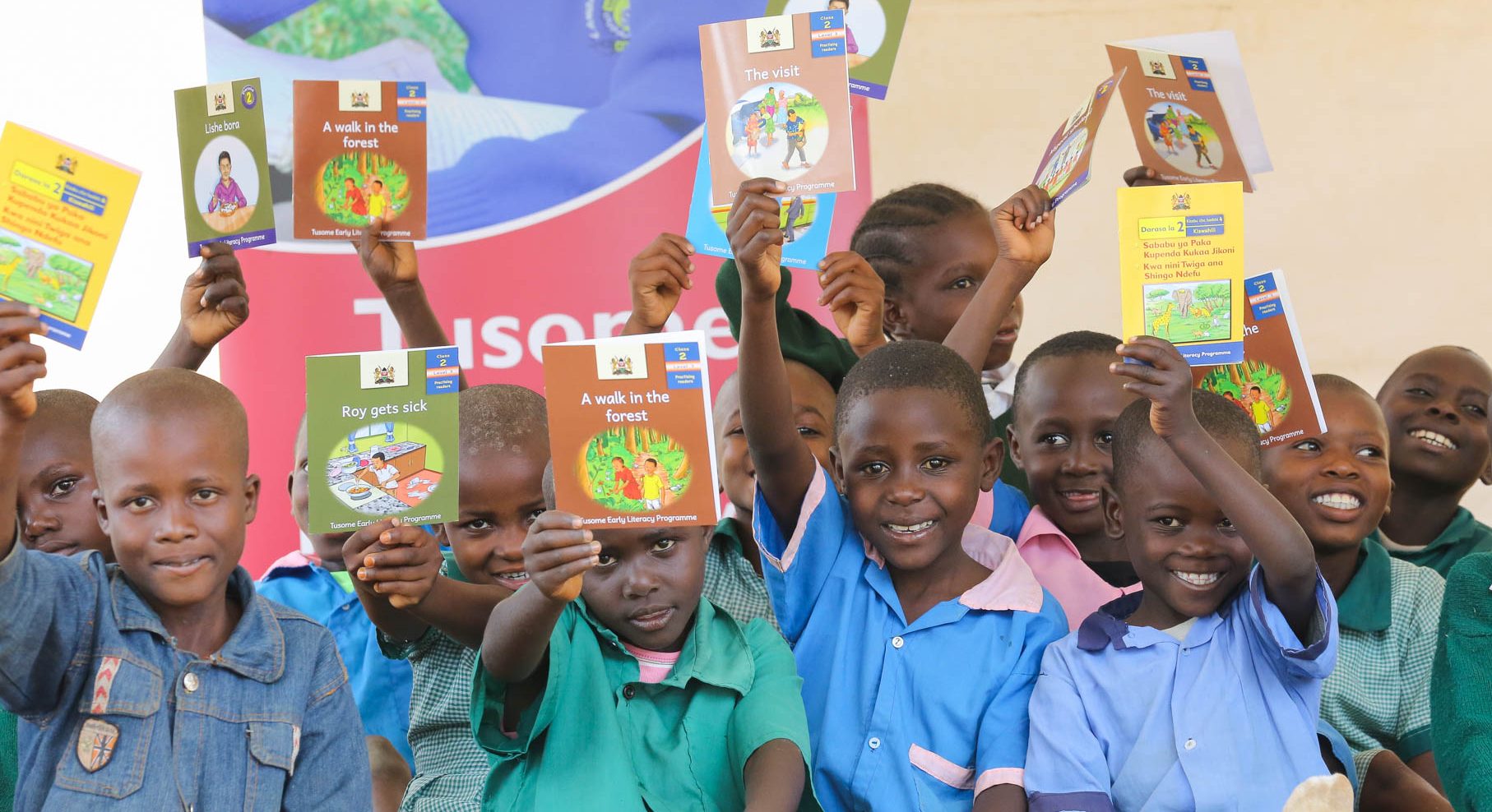 A group of school children from Kenya holding up books